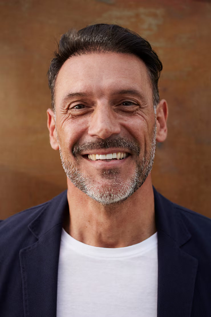 files/middle-aged-man-wearing-jacket-laughing-happy_150588-72.avif